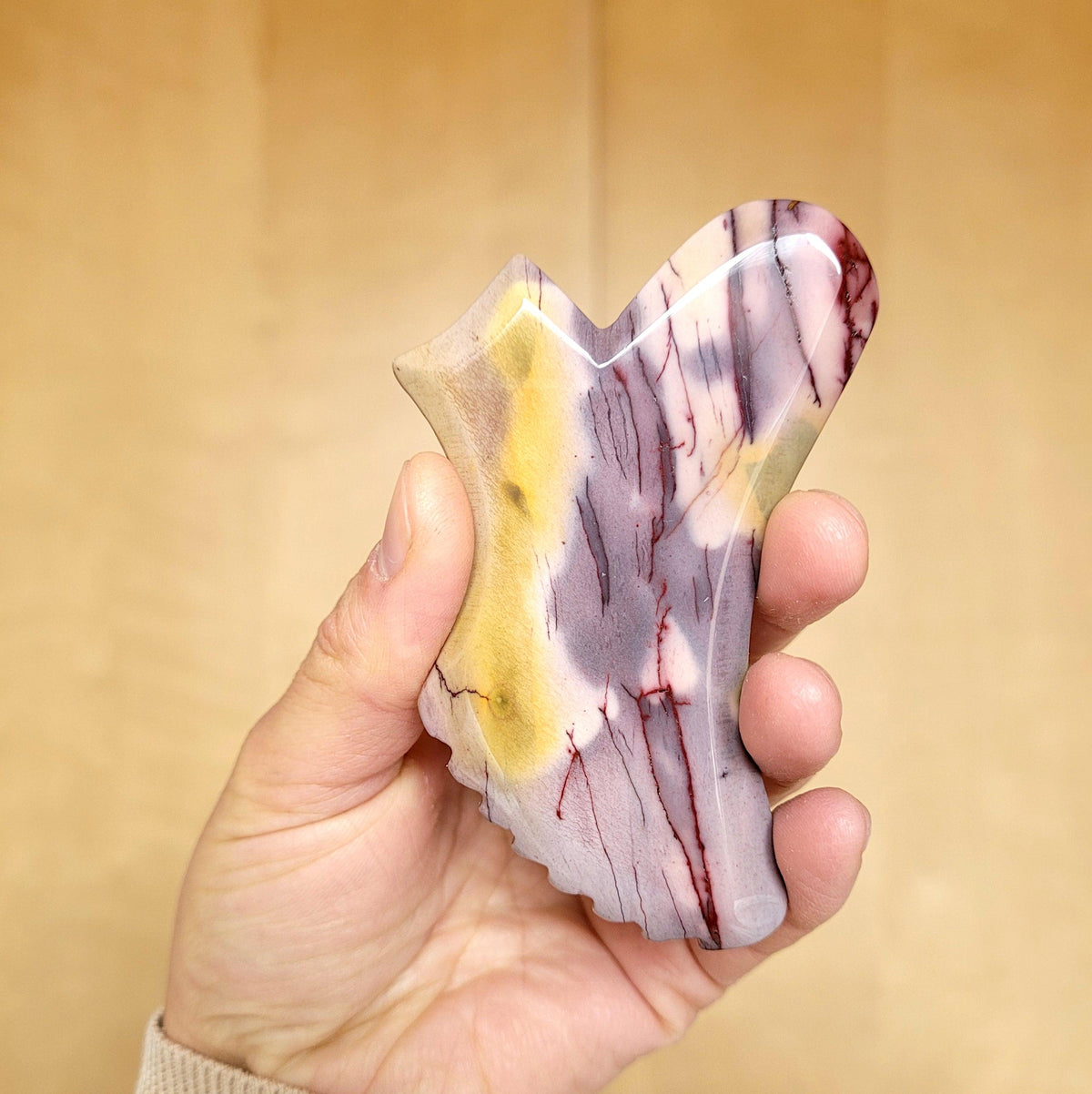 Jasper gua sha to massage facial pressure points